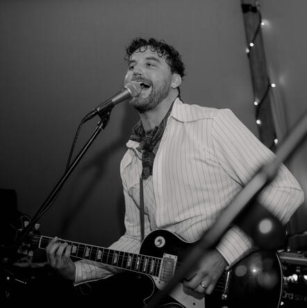 The Gastric Band performing at a London wedding reception The guitarist serenading the crowd at a London function